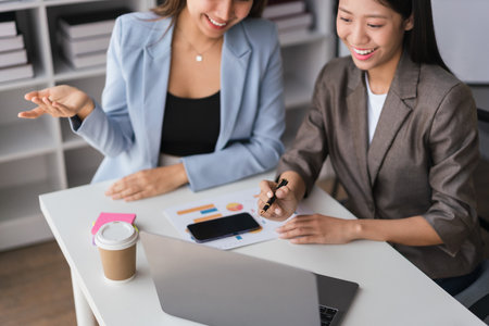 Two businesswomen working on laptop to discussion and brainstorming about strategy of new business.の写真素材
