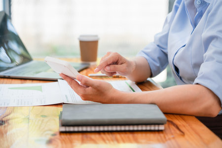 Businesswomen use calculator to calculate profit business with happiness while working in workplace.