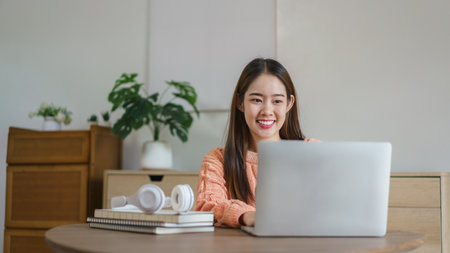 Women sitting on the floor and working to typing business data on laptop in lifestyle at home.