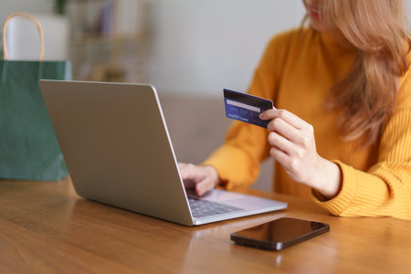 Work from home concept, Businesswoman is typing credit card data on laptop to shopping online.の写真素材