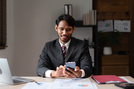 Businessman using smartphone to researching data and analyzing strategy of startup business project.の写真素材