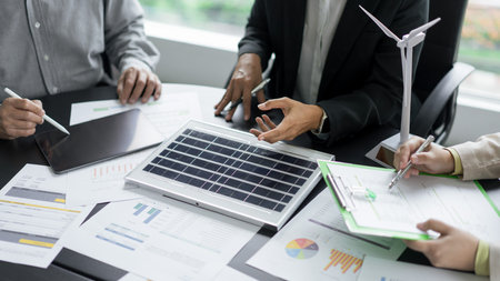 Alternative energy environment business team discuss about solar cell panel and renewable energy.の写真素材