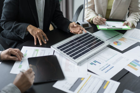 Alternative energy environment business team discuss about solar cell panel and renewable energy.の写真素材