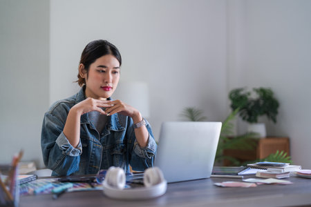 Graphic designer women read data on laptop to thinking and working designing about graphic design.