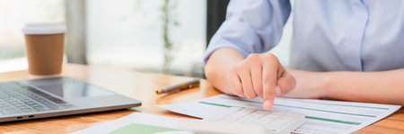 Businesswomen use calculator to calculate profit business with happiness while working in workplace.