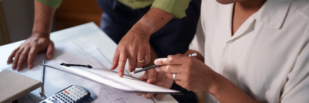 A detailed discussion between engineers about building requirements and material optimization for a large project.の写真素材