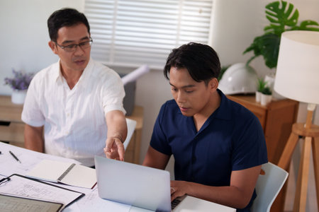 A professional engineering team working on cost estimation and resource allocation for a building project.の写真素材