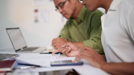 A professional engineering team working on cost estimation and resource allocation for a building project.の写真素材