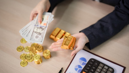 Adult hands meticulously evaluate gold bars dollar bills assets on a desk Strategic financial...