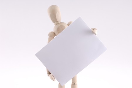 wooden man holding paper note  isolated on white backgroundの写真素材