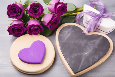 Bouquet of purple roses, gift box and heart on a wooden backgroundの素材