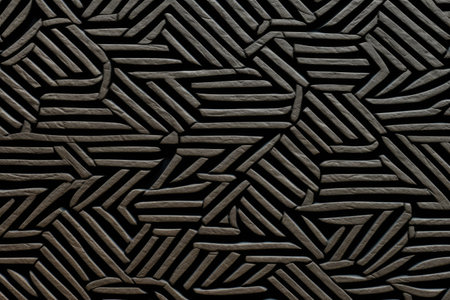 Abstract black metal background with a pattern of wavy lines and holesの素材