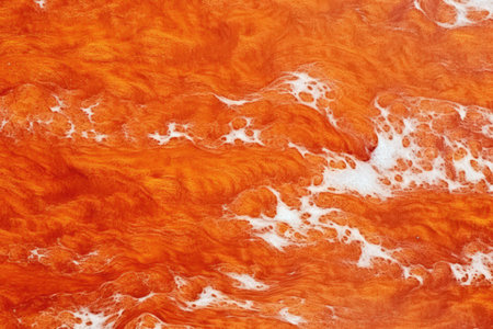 abstract background of red and orange watercolor paint on the paperの素材
