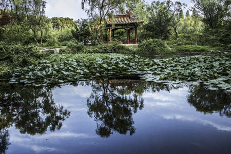 Chinese Pavilion reflected in a pond in the Ming Xiaoling Tomb in Nanjing Chinaの写真素材
