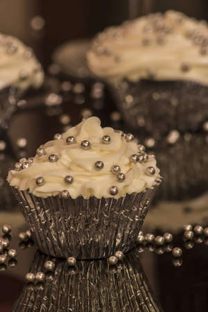 White cupcake with silver decorationsの写真素材