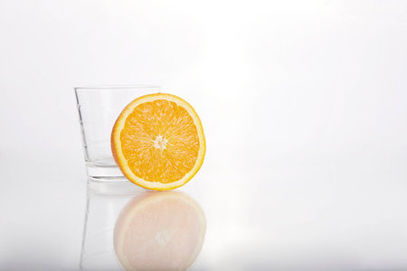 orange with empty glassの写真素材