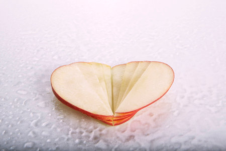 red apple heart on white backgroundの写真素材