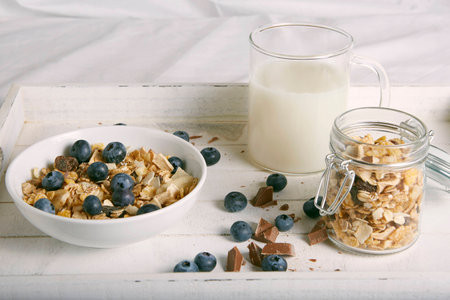 breakfast with cereals, blueberries, chocolate and milk