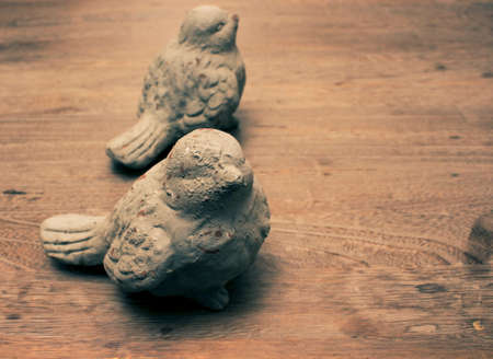Bird decoration objects on wood tableの写真素材