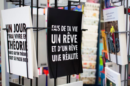 PARIS - JULY, 2016: Close up view of French postcards on racks about humour on Rue Montorgueil street in Paris.のeditorial素材