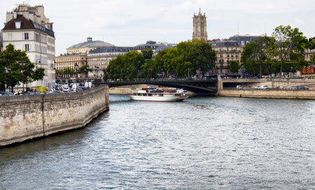 PARIS - JULY, 2016: View of a boat on Seine river and Paris cityscape.のeditorial素材