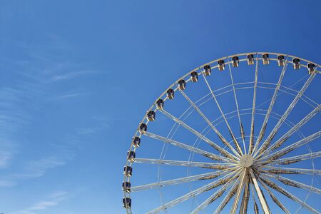 Half view of ferris wheel with blue sky background at Jardin Des Tuileries in Paris.の写真素材