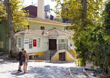 Man and woman tourists look at map to find where to go in front of Muhyiddin Molla Fenari Mosque in Cukurcuma area of Beyoglu district near Istiklal avenue on European side of Istanbul.の写真素材