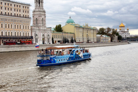 Blue, traditional tour boat on Moskva river in Moscow. Cathedral of Christ the Saviour is in the background.のeditorial素材
