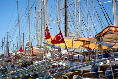 Many yachts parked at Bodrum marina. Turkish flags wave. A lot of masts are also in the view.のeditorial素材