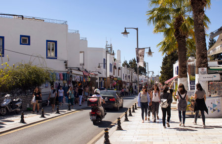 Tourists and local people walk on the main shopping street in Bodrum city. It's a sunny day in summer.のeditorial素材