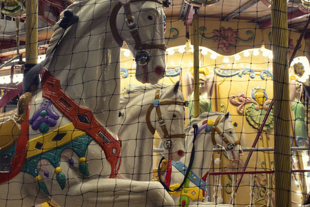 Close up view of horses of a carousel in front of Hotel De Ville Paris. Childhood, nostalgic fun concept.の写真素材