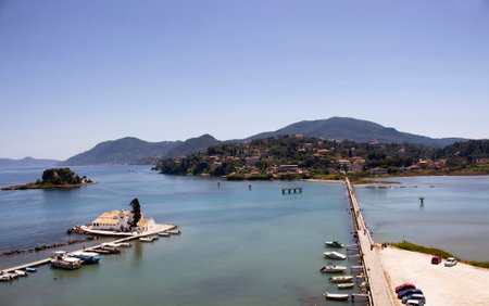 Aerial view of iconic Vlacherna and Pontikonisi Monasteries in Corfu (Kerkyra). Small fishing boats,...