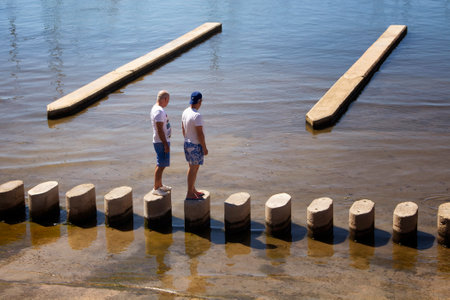 Two men stand and look at sea at Palma de Mallorca marina. It's a resort city and capital of the Spanish island of Majorca in the western Mediterranean.のeditorial素材