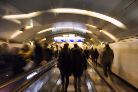 Blurry motion image of people walking horizontal escalators in subway station in Paris. (Sortie means exit in French)の写真素材