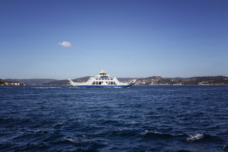 Public transportation vehicle for cars and people (ferry boat) crossed Bosphorus in a sunny summer day in Istanbul. Asian side is in the background.の写真素材