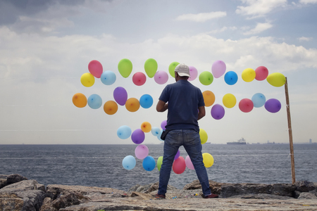 View of an unrecognizable balloon man standing by Bosphorus. Image is captured in the neighborhood called Moda located on the Asian side of Istanbul.の写真素材