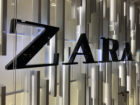 Close up view of signage of Spanish international fashion company's store at Barcelona El Prat airport.のeditorial素材
