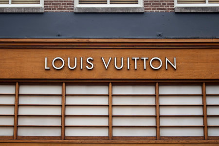 Close up view of signage of French fashion house and luxury retail company on luxury shopping street named "Pieter Corneliszoon Hooft" in Amsterdam. It is a summer day.のeditorial素材