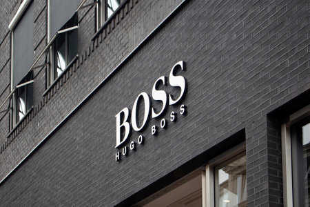 View of signage of German fashion goods manufacturer's store on on luxury shopping street named "Pieter Corneliszoon Hooft" in Amsterdam. It is a summer day.のeditorial素材