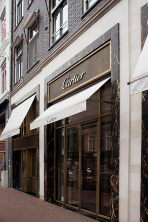 View of store of French jewellery and watch manufacturer's store on on luxury shopping street named "Pieter Corneliszoon Hooft" in Amsterdam. It is a summer day.のeditorial素材
