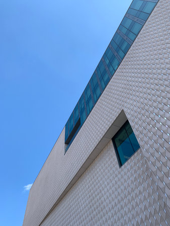 Bottom view of newly opened contemporary art museum in Istanbul with clear blue sky background. It...