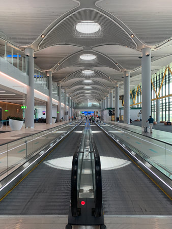 View of people walking on moving walkways at new Istanbul airport.