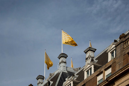 Close up bottom view of famous department store's flags in Amsterdam. It is a sunny summer day with clear blue sky.のeditorial素材