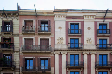 View of old, historical, traditional buildings in Barcelona showing Spanish / Catalan architectural style and culture. It is a sunny summer day.のeditorial素材