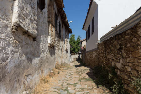 View of narrow street, old historical houses in famous, touristic Aegean mountain village called "Sirince" in Izmir, Turkey. It is a sunny summer day.の写真素材