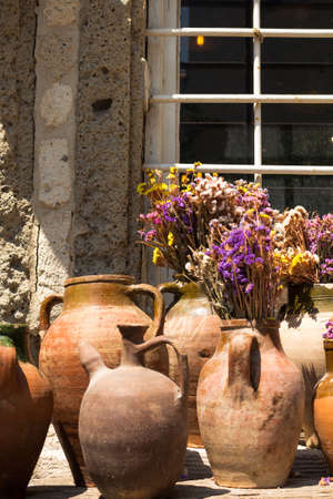 View of old, historical, traditional ceramic pottery with colorful flowers. Handmade amphora works...