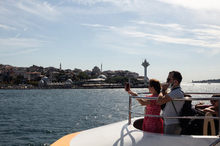 View of tourists on cruise tour boat on Bosphorus in Ä±stanbul. It is a sunny summer day.のeditorial素材