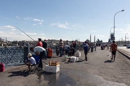 View of people walking and fishermen on Galata bridge in Eminonu area of Istanbul. The image...