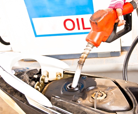 Nozzle  fuel pointing down on the tank to the fuel.の写真素材
