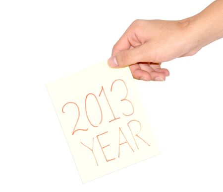 Hand holding a paper notebook wrote that in 2013の写真素材